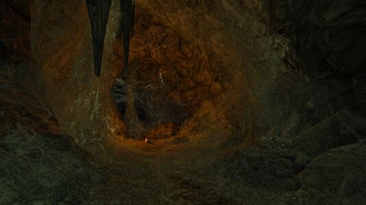 Torches left by a previous spelunker are strewn across the caverns